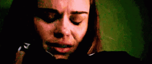 a close up of a woman crying with her eyes closed .