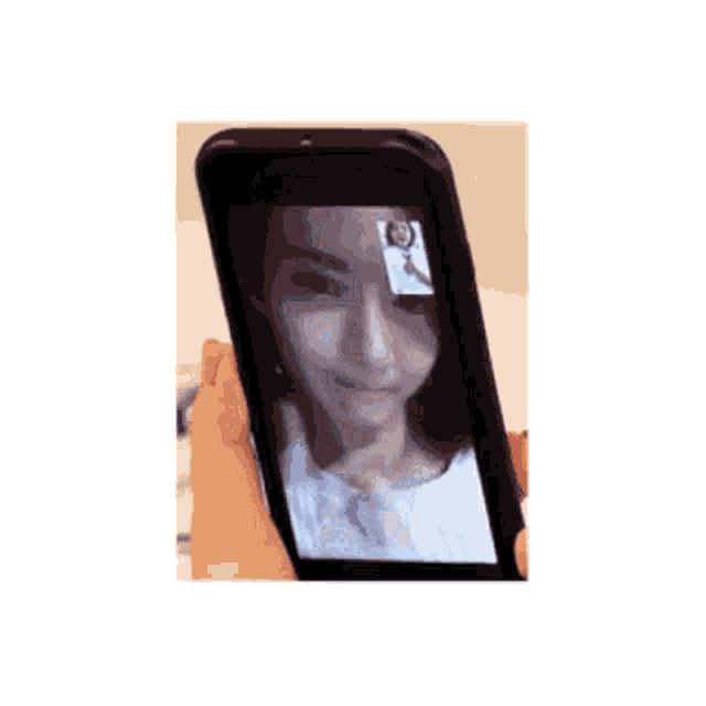 a person is taking a picture of a woman 's face on a cell phone .