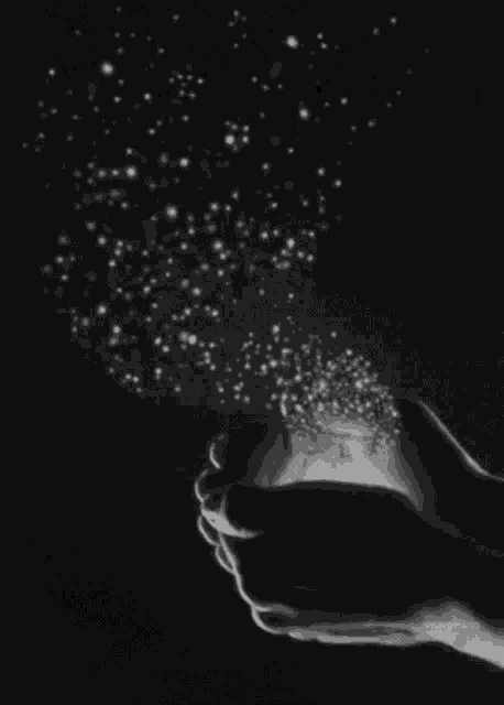 a black and white photo of a person holding stars in their hands .