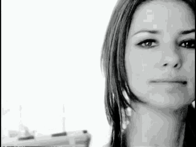 it is a black and white photo of a woman 's face .