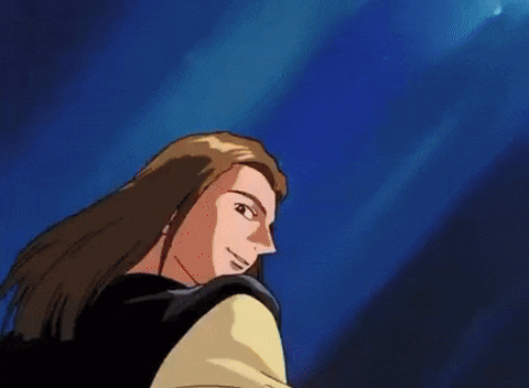 a man with long hair is smiling in front of a blue sky