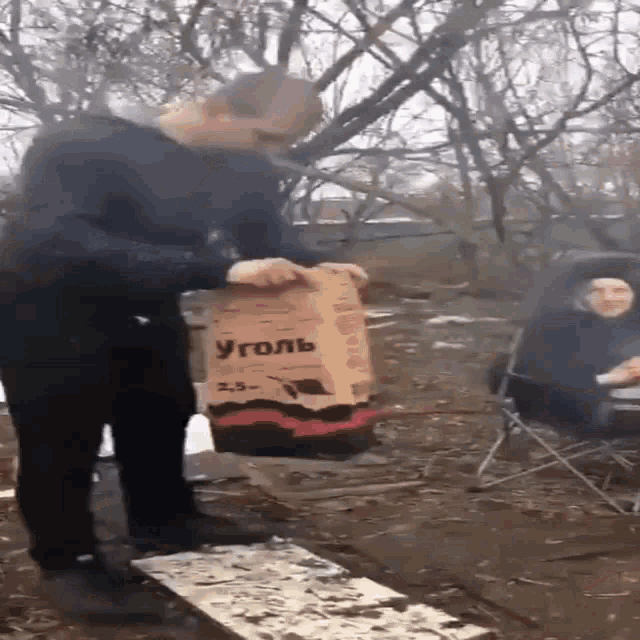 a man is holding a bag that says уголь 2.5