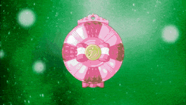 a pink circular object with a gold heart on it