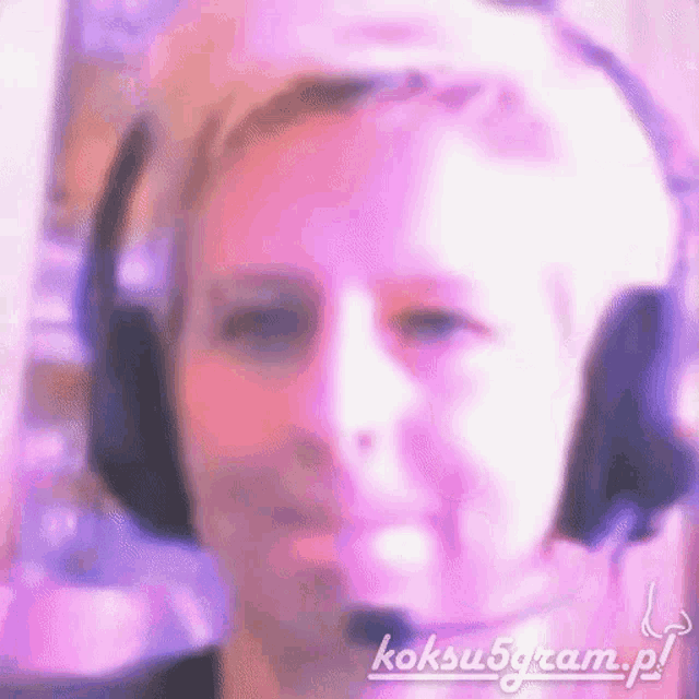 a woman wearing headphones and a microphone is making a funny face .