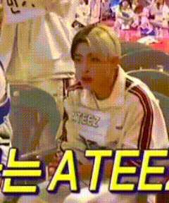 a person is sitting in a chair with the words eatee written on the screen .