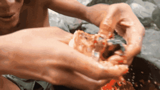 a close up of a person holding a piece of pizza