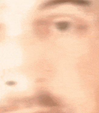 a blurry picture of a man 's face with a beard and mustache .