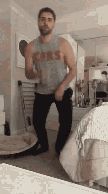 a man wearing a tank top that says ' ers ' on it