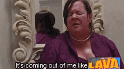 a woman is standing in front of a mirror with the words it 's coming out of me like lava above her