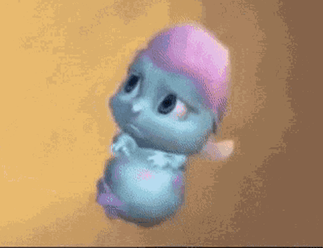a cartoon character is being held by a person 's hand while flying through the air .