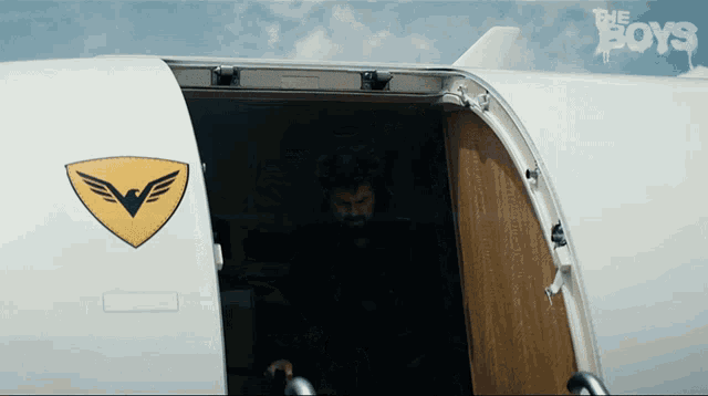 a man is walking out of an airplane with the boys written on the side