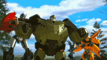 a group of transformers are standing together in a field