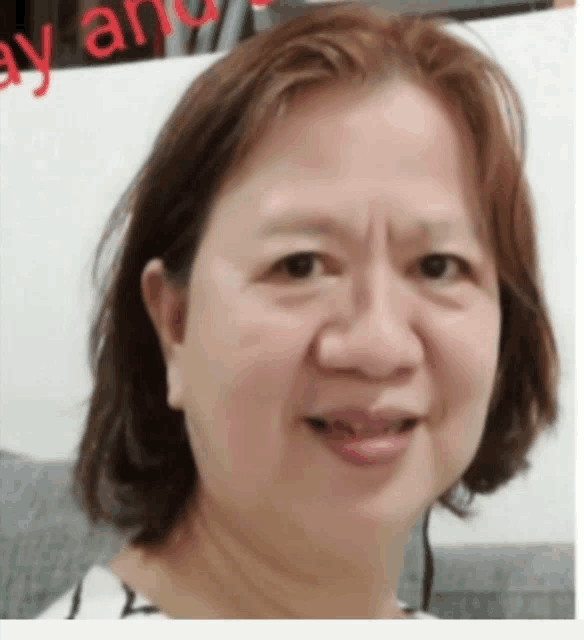 a close up of a woman 's face with a sign that says may and
