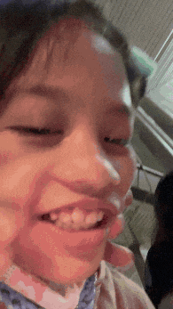 a close up of a child 's face with a smiley face