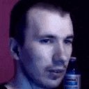 a man is holding a bottle of water in his hand .