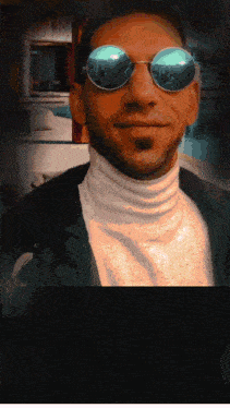 a man wearing a white turtleneck and sunglasses