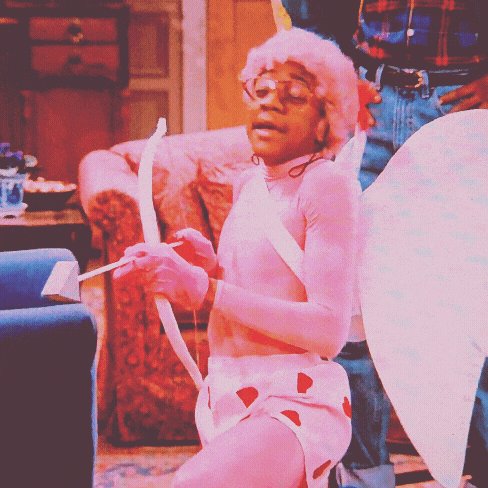 a man dressed as a cupid with a bow and arrow