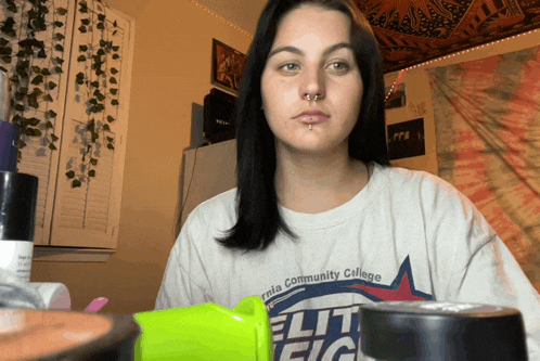 a woman wearing a t-shirt that says ' california community college ' on it