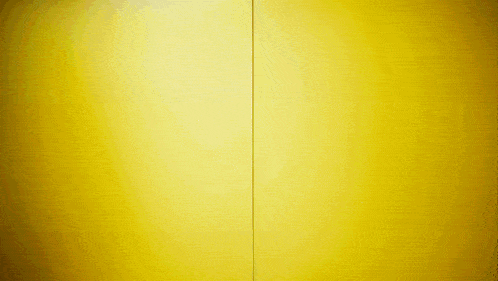 a yellow wall with a red stripe on the bottom