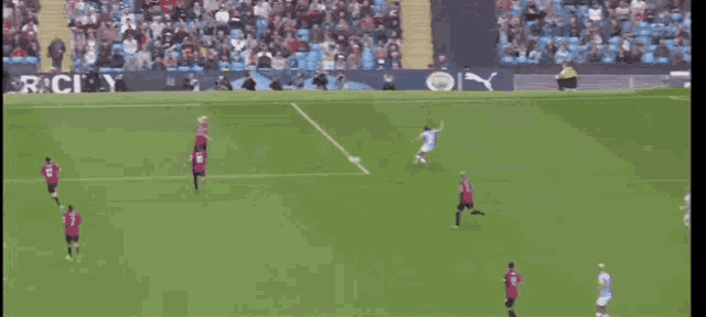 a soccer game is being played in front of a banner that says city