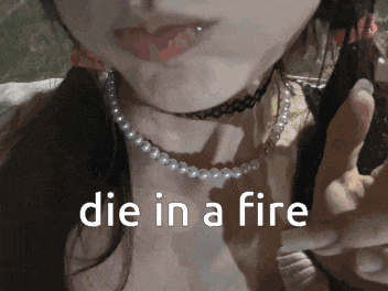 a close up of a woman 's face with the words die in a fire on the bottom