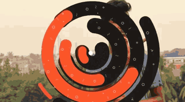 a man is standing in front of a swirl that looks like a spiral