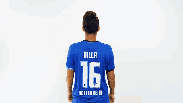 a woman in a blue billa 16 hoffenheid jersey