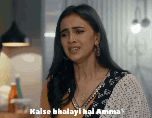 a woman with a necklace and earrings says " kaise bhayali hai amma "