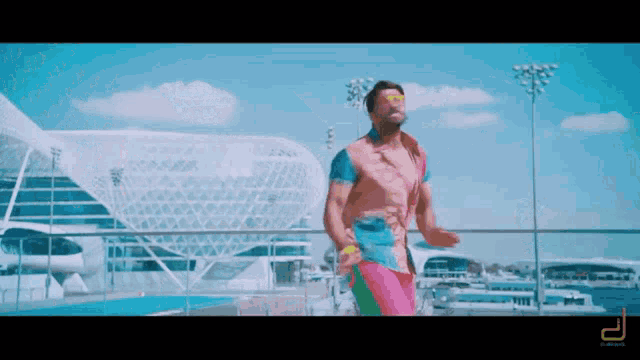 a man in a colorful outfit is dancing in front of a building
