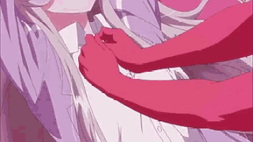 a person is holding another person 's arm while they are laying down .