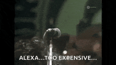 a man is singing into a microphone and saying `` alexa too expensive ... ''