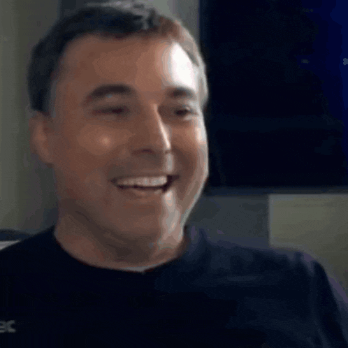 a close up of a man 's face with his eyes closed and smiling .