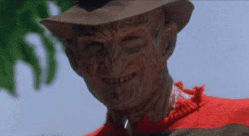a close up of freddy krueger with a knife in his neck