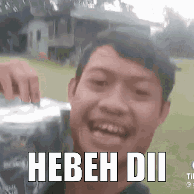 a man is making a funny face and the words hebeh dii are on the bottom