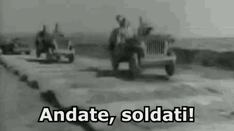 a black and white photo of a jeep driving down a road with the words andate soldati .