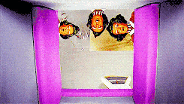 a group of people standing upside down in a room