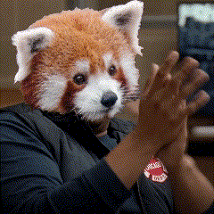 a man wearing a red panda mask clapping his hands