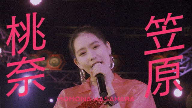 a woman singing into a microphone with momona kasahara written on the bottom right
