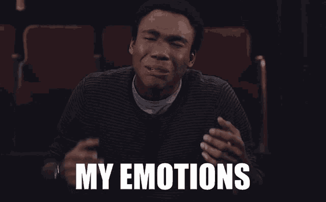 a man sitting in a theater with his eyes closed and the words " my emotions " on the bottom