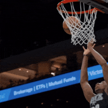 a basketball player with the number 86 on his jersey goes up to dunk the ball