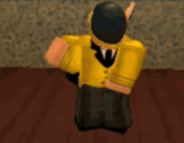 a cartoon character in a yellow suit and black hat is kneeling down