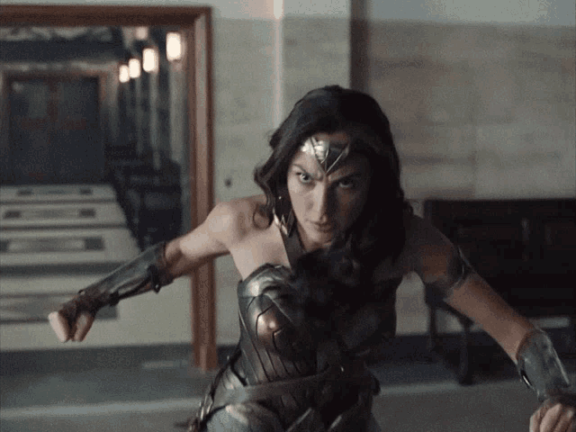 a woman in a wonder woman costume is holding a sword