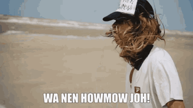 a woman wearing a white shirt and a black hat with the words wa nen howmow joh on the bottom