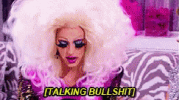 a drag queen is sitting on a zebra print couch and talking bullshit .