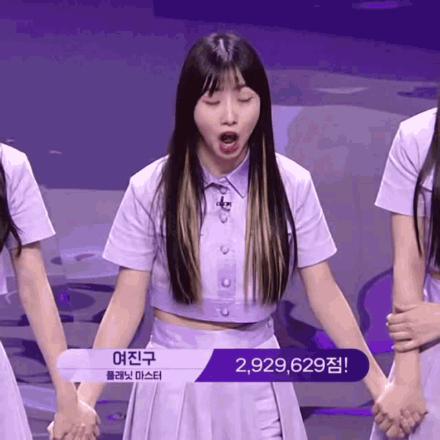 a girl in a purple dress has the number 2,929,629 on the bottom right