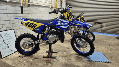 a yamaha dirt bike with the number 486 on the side