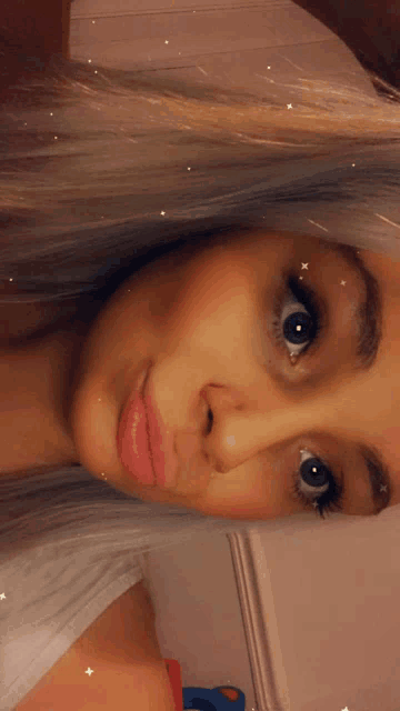 a close up of a woman 's face with a white background