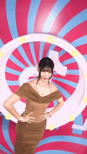 a woman in a brown dress is standing in front of a pink and blue swirl