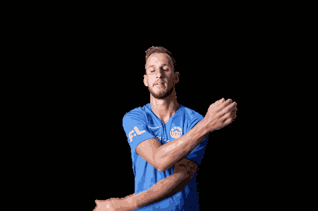 a man in a blue shirt with the letter fl on the sleeve