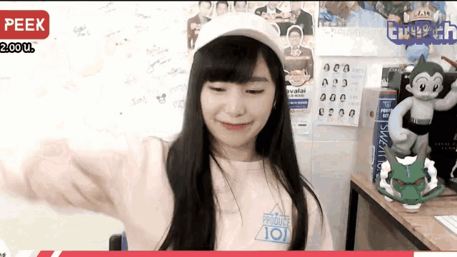 a girl wearing a white hat and a pink shirt that says 101 on it